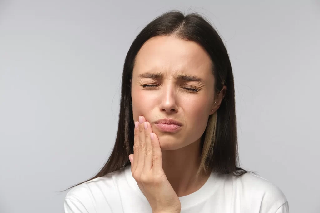 Woman feeling toothache pain.