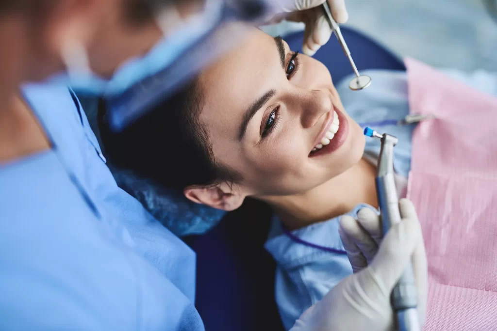 woman getting teeth cleaning procedure