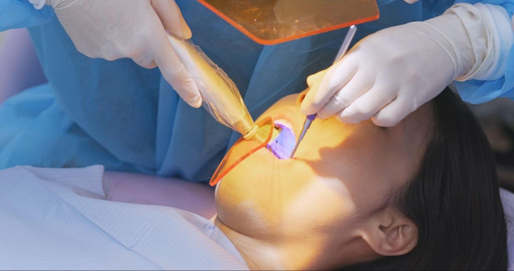 Close-up of a woman having her teeth examined during a dental visit.